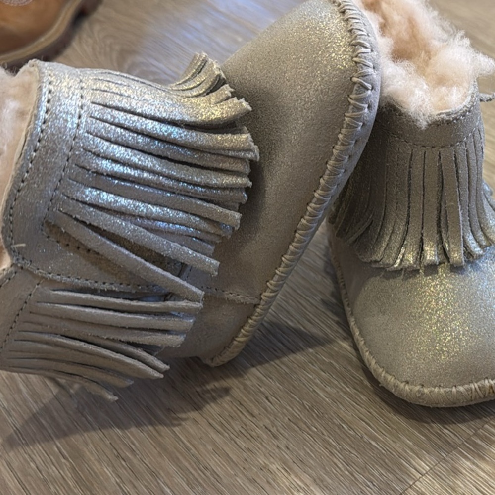 UGG, silver moccasin booties brand new used once in the house